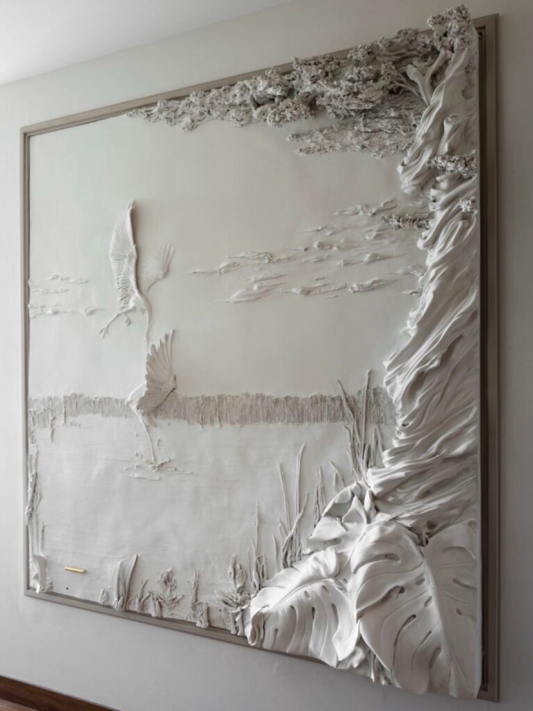 Textured wall sculpured. Herons and trees around a lake.